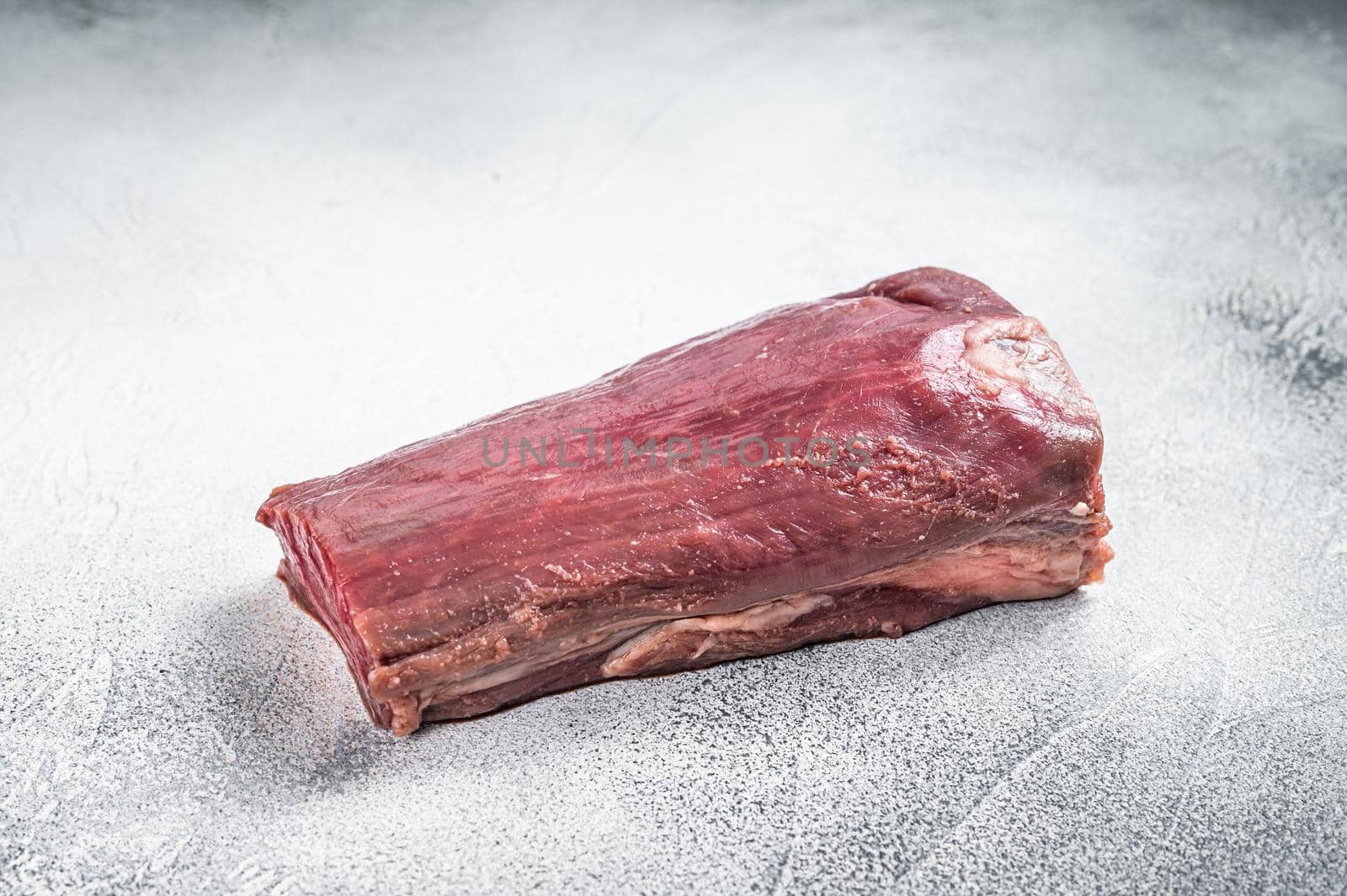 Beef Tenderloin raw meat on butcher table. White background. Top view.