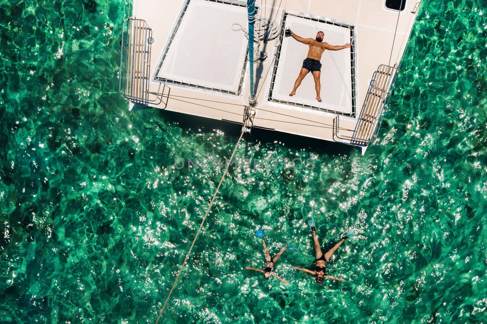 young handsome man lies on a yacht in the indian ocean.mauritius island by Lobachad