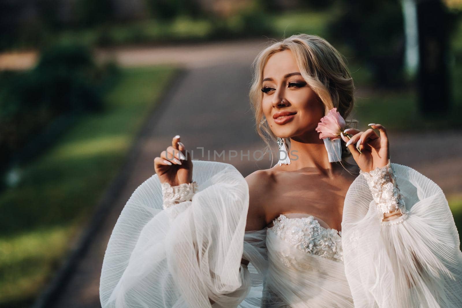 beautiful young bride in luxury white wedding dress . Portrait of a cute bride in summer field. happy Wedding day. Beautiful bride with makeup and hairstyle