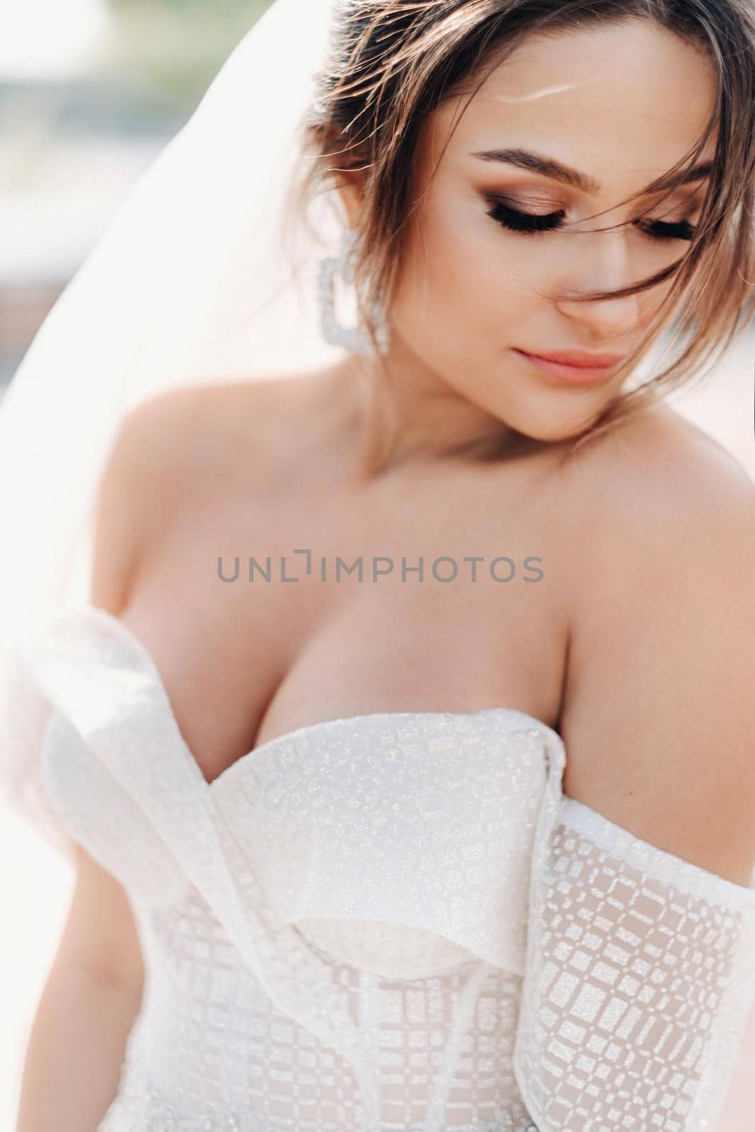 Portrait of the bride in close-up.A stunning young bride with curly hair . Wedding day. . Beautiful portrait of the bride without the groom