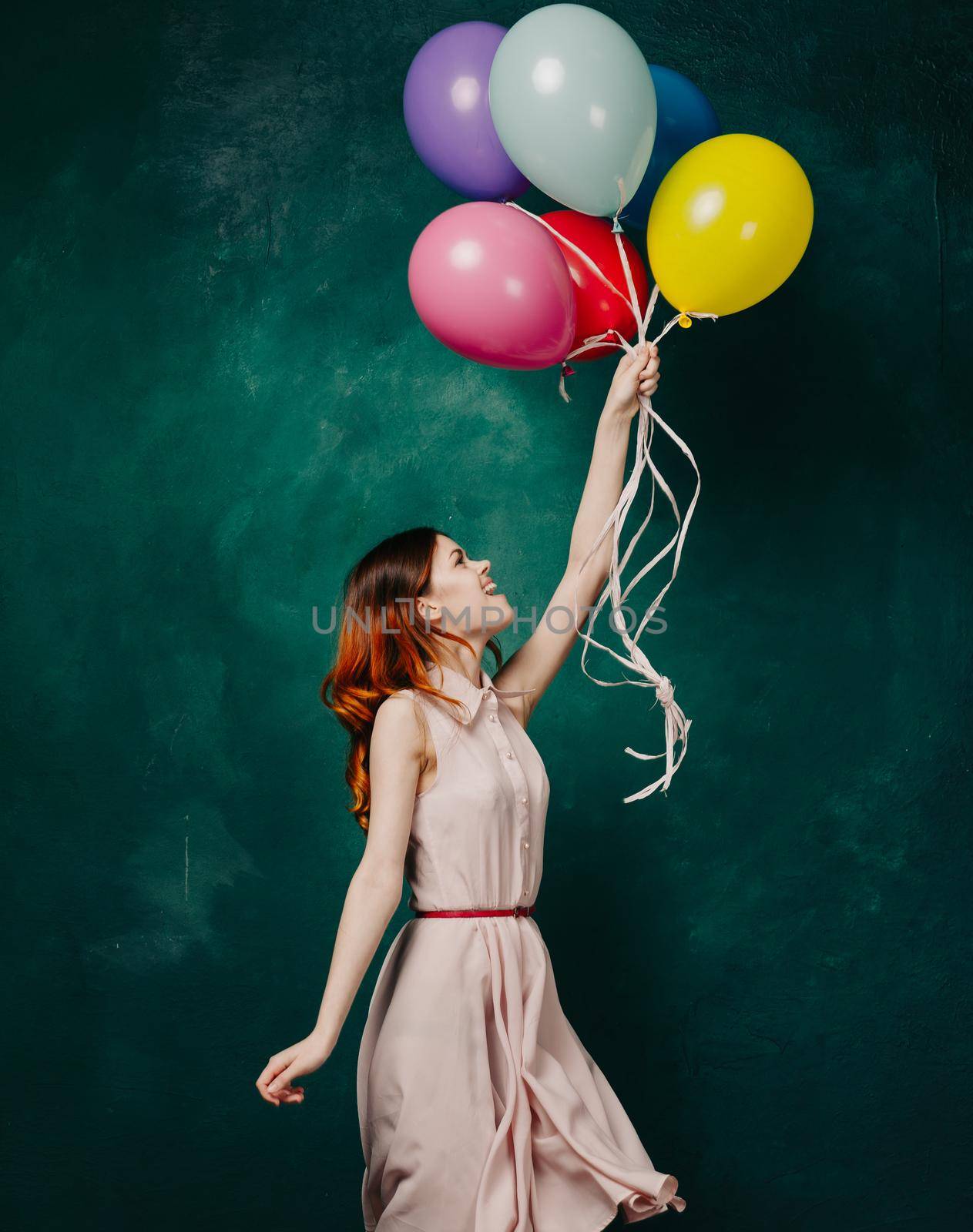 cheerful woman with colorful balloons birthday fun. High quality photo