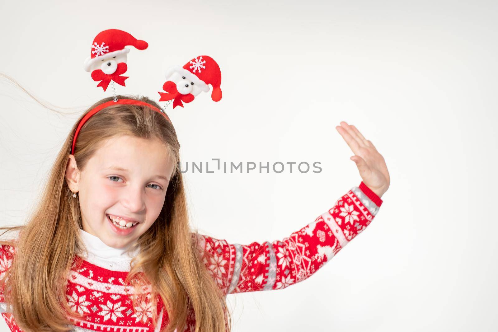 Portrait of excited funny funky schoolchild dancing in christmas costume with headband isolated on white background.Ready For Christmas party.Merry Christmas presents shopping sale concept. by YuliaYaspe1979