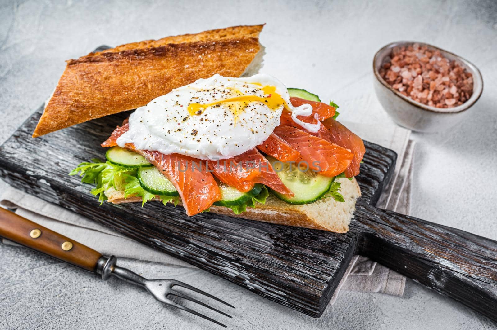 Sandwich with Poached egg, smoked salmon and avocado on toast. White background. Top view by Composter