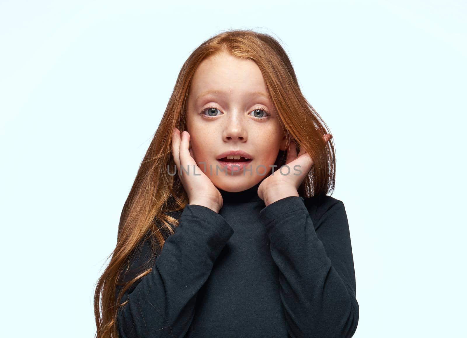 red-haired girl in a black sweater planning close-up. High quality photo