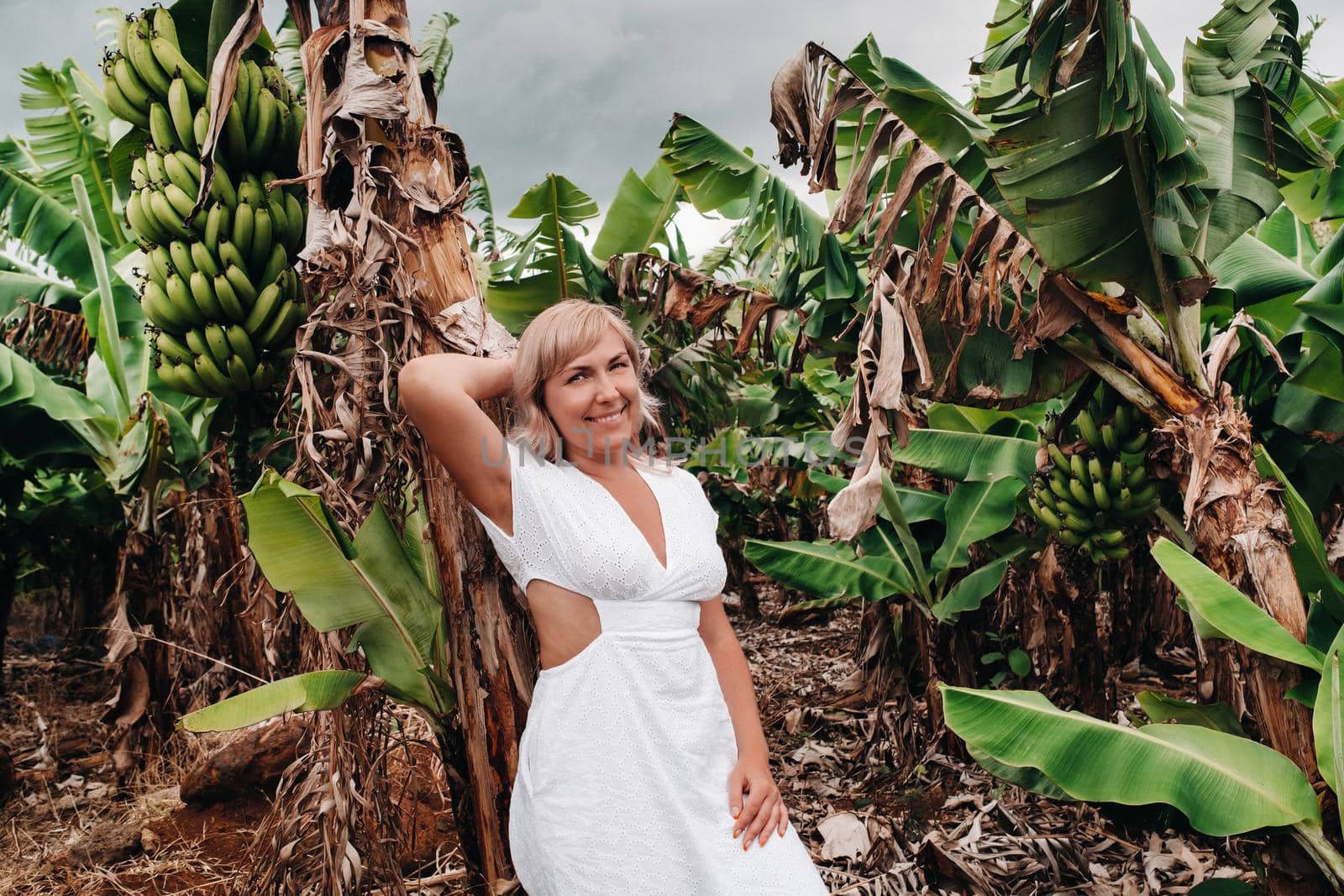 A girl on a banana plantation on the island of Mauritius, a Banana farm on a tropical island, a Girl in a white dress on a plantation in Africa by Lobachad