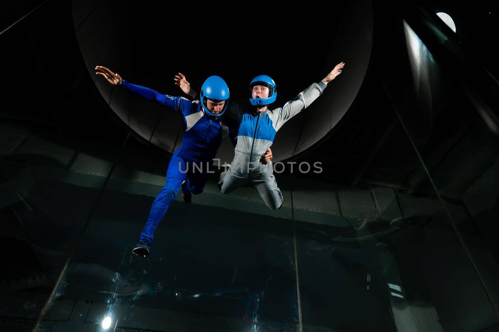 A man and a woman enjoy flying together in a wind tunnel. Free fall simulator by mrwed54