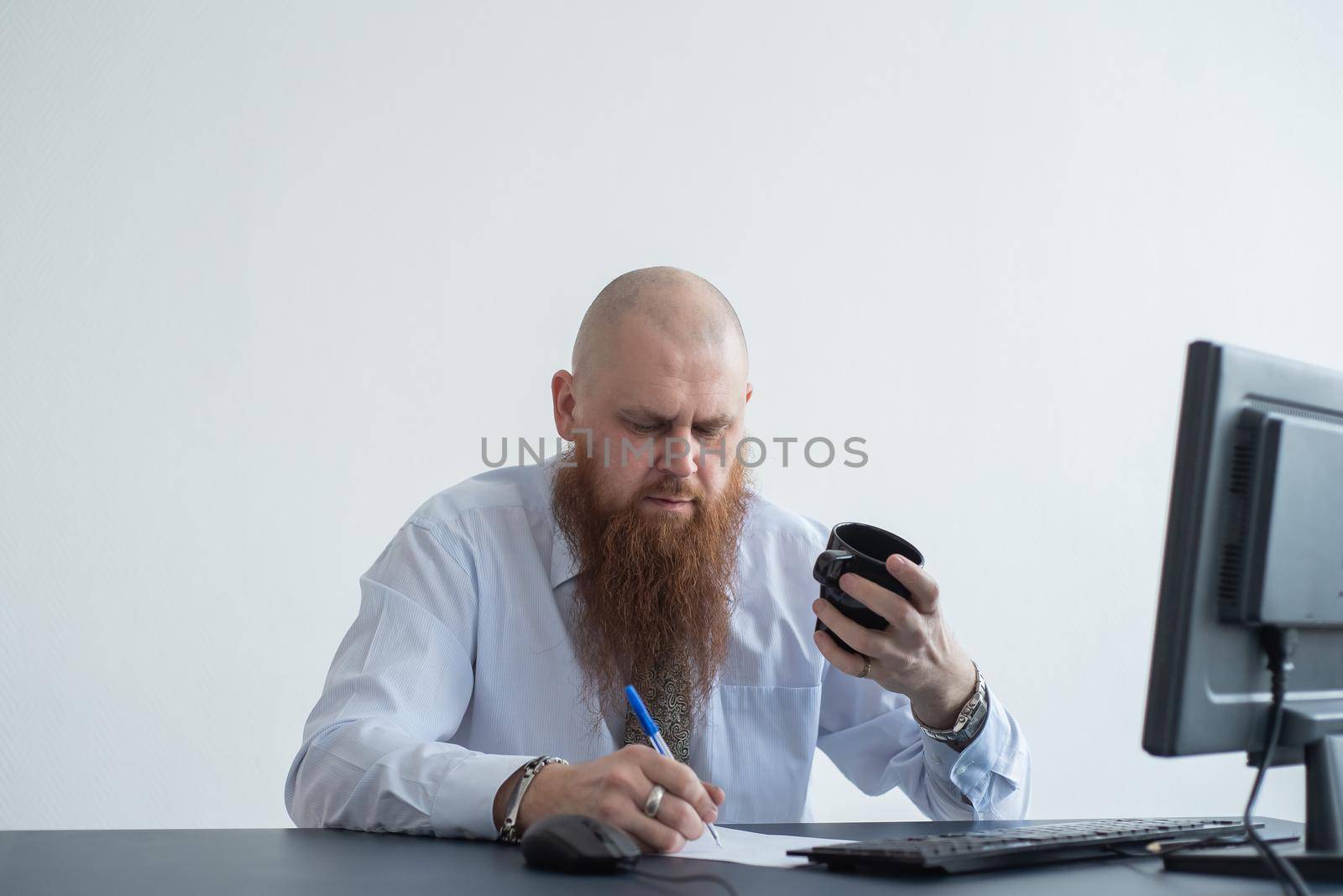 Problems for the office worker. A bald man in a white shirt sits at a desk with a computer and is stressed because of failure. A nervous breakdown. by mrwed54