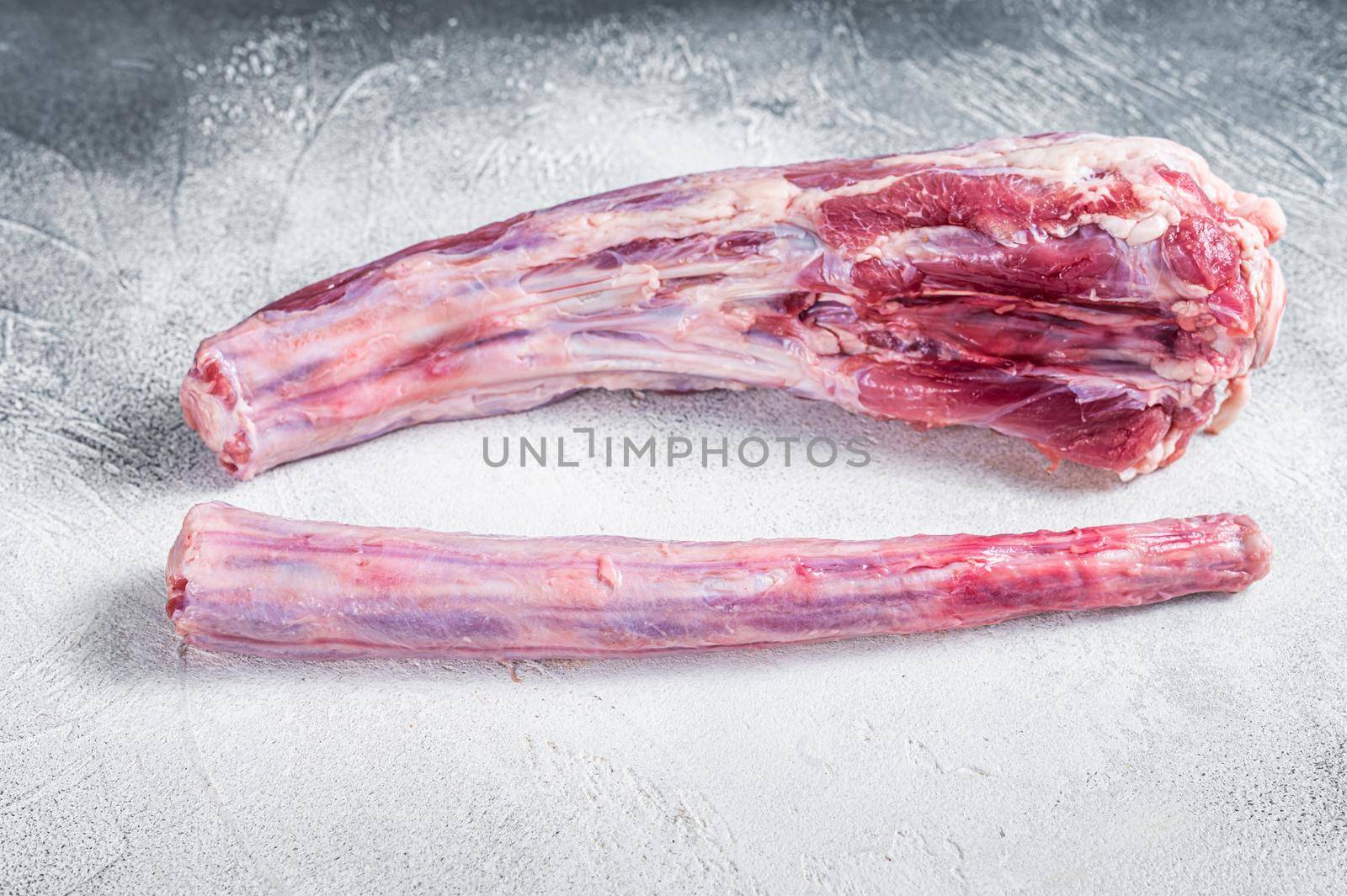Raw whole Beef veal Oxtail Meat on butcher table. White background. Top view by Composter
