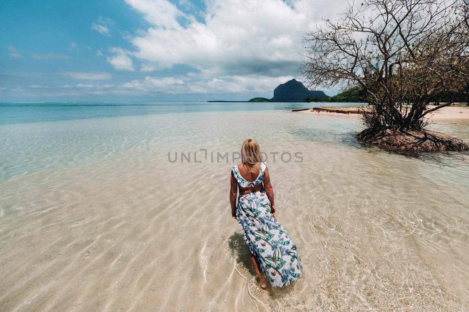 Young woman in a swimsuit relaxing on a tropical beach. Tropical vacation in paradise.mauritius island.