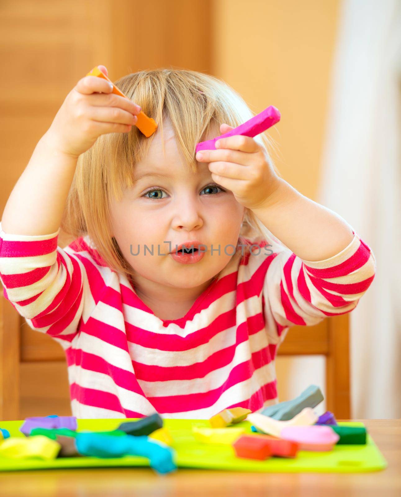 Little girl playing with plasticine by GekaSkr