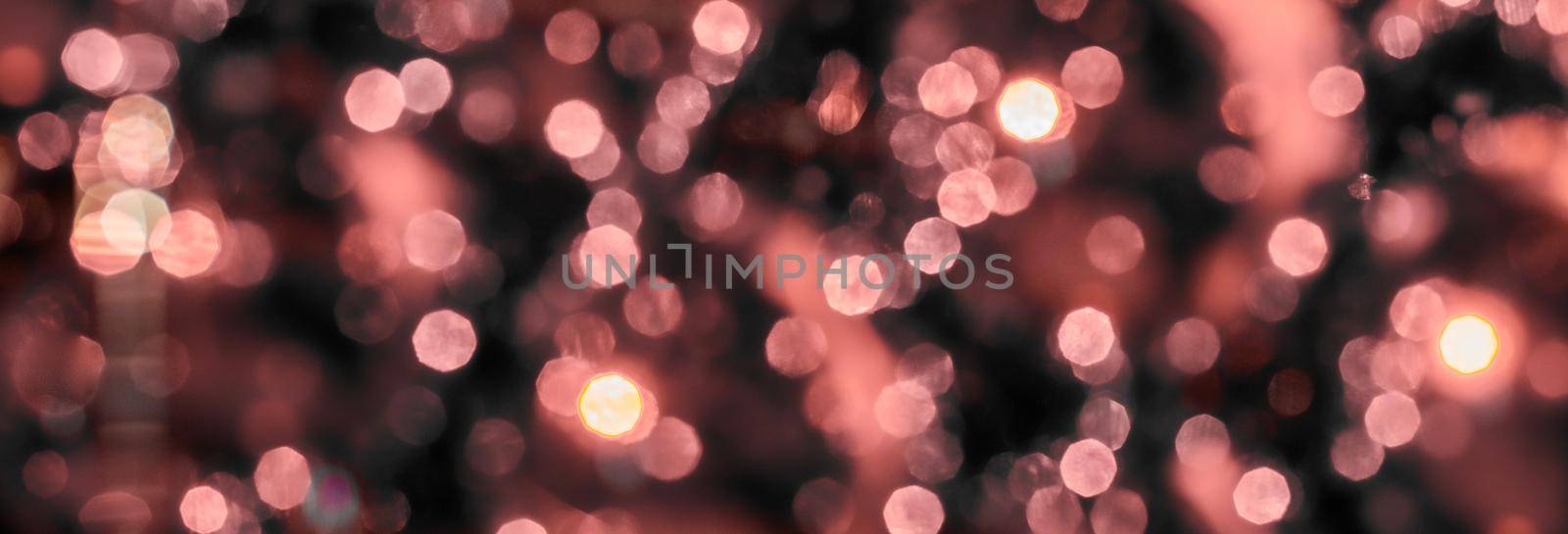 Pink holiday bokeh. Abstract Christmas background.Magic holiday abstract glitter background with blinking stars and falling snowflakes. Blurred bokeh of Christmas lights.WEb banner by YuliaYaspe1979