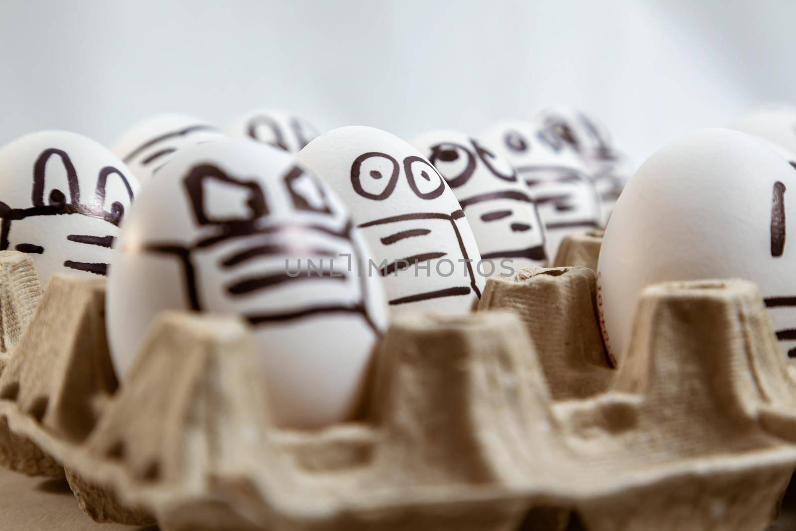 close up of set of Easter eggs with drawn medical masks and emotions. copy space
