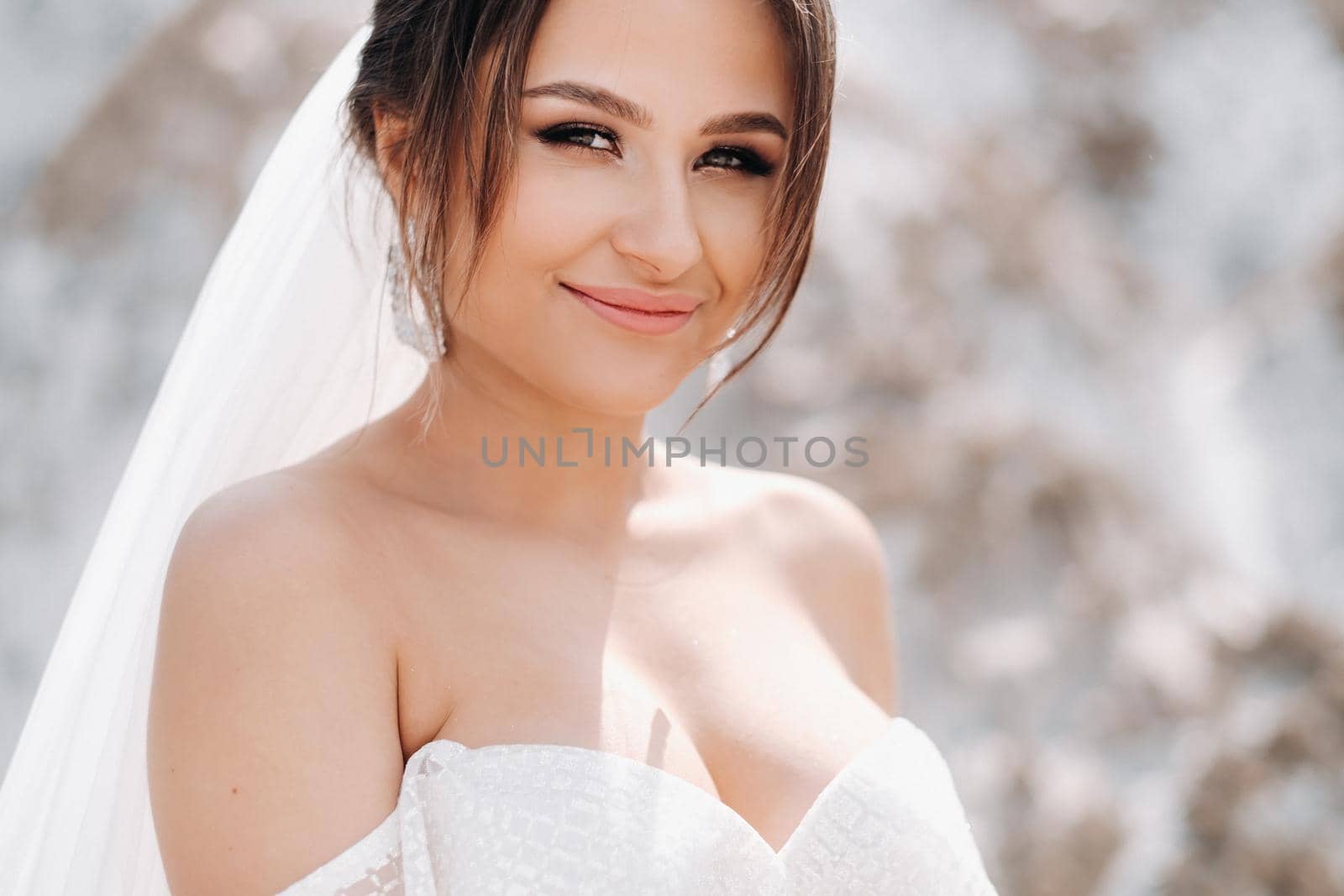 Beautiful bride in a wedding dress on top of the salt mountains. A stunning young bride with curly hair . Wedding day. . Beautiful portrait of the bride without the groom. by Lobachad