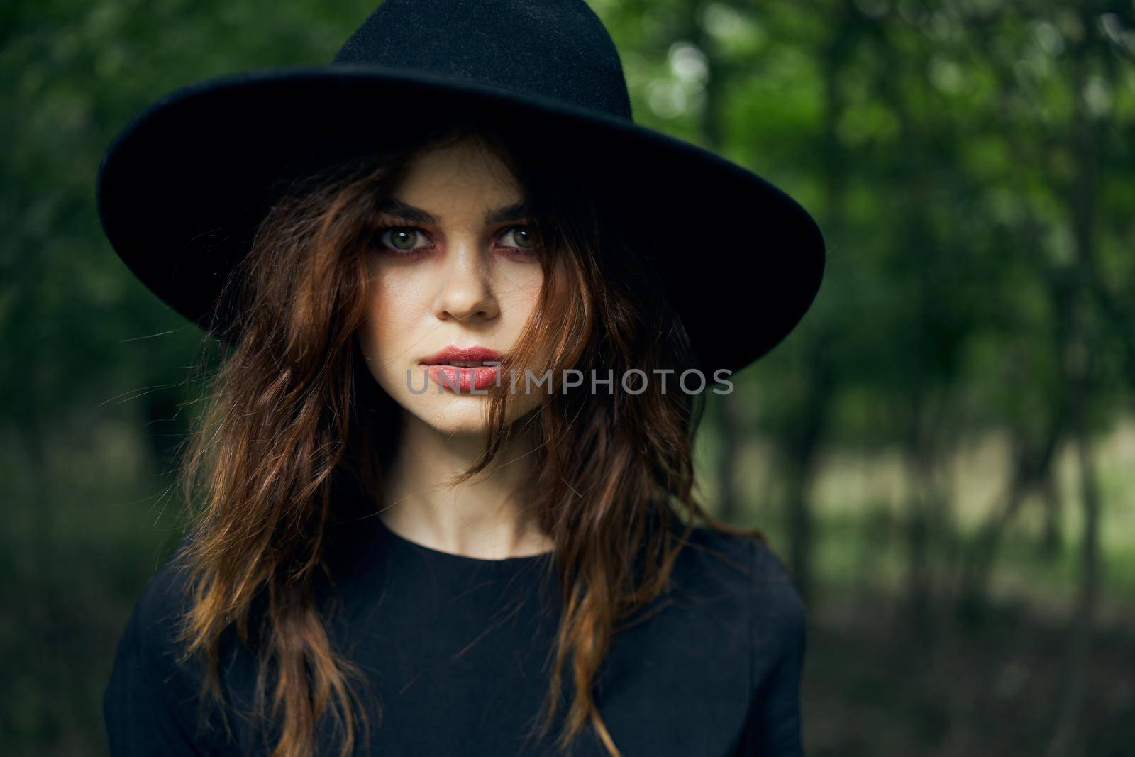 woman dressed as a witch in the forest Halloween fantasy ritual. High quality photo