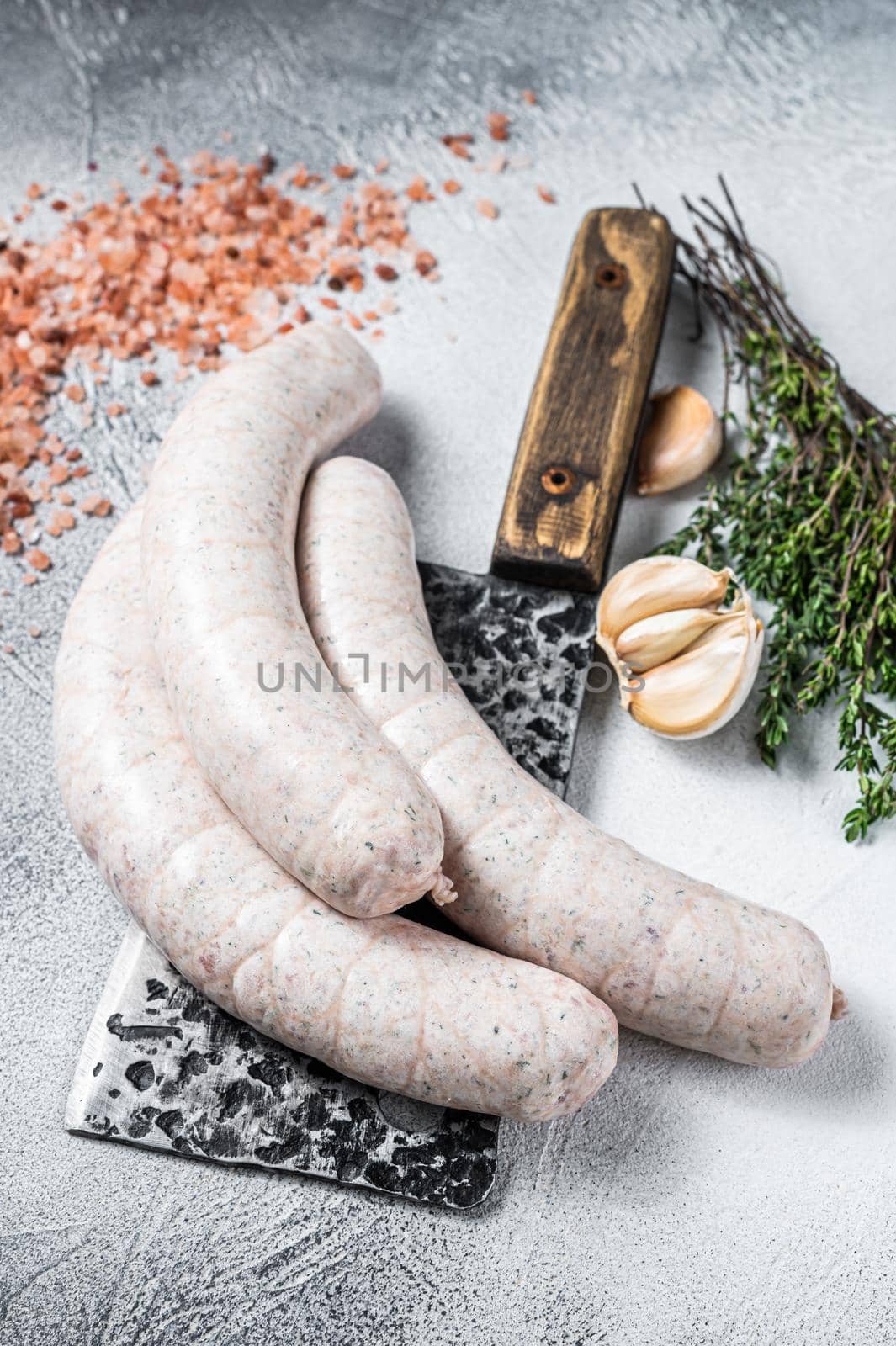 Bavarian traditional white sausages on a meat cleaver. White background. Top view by Composter