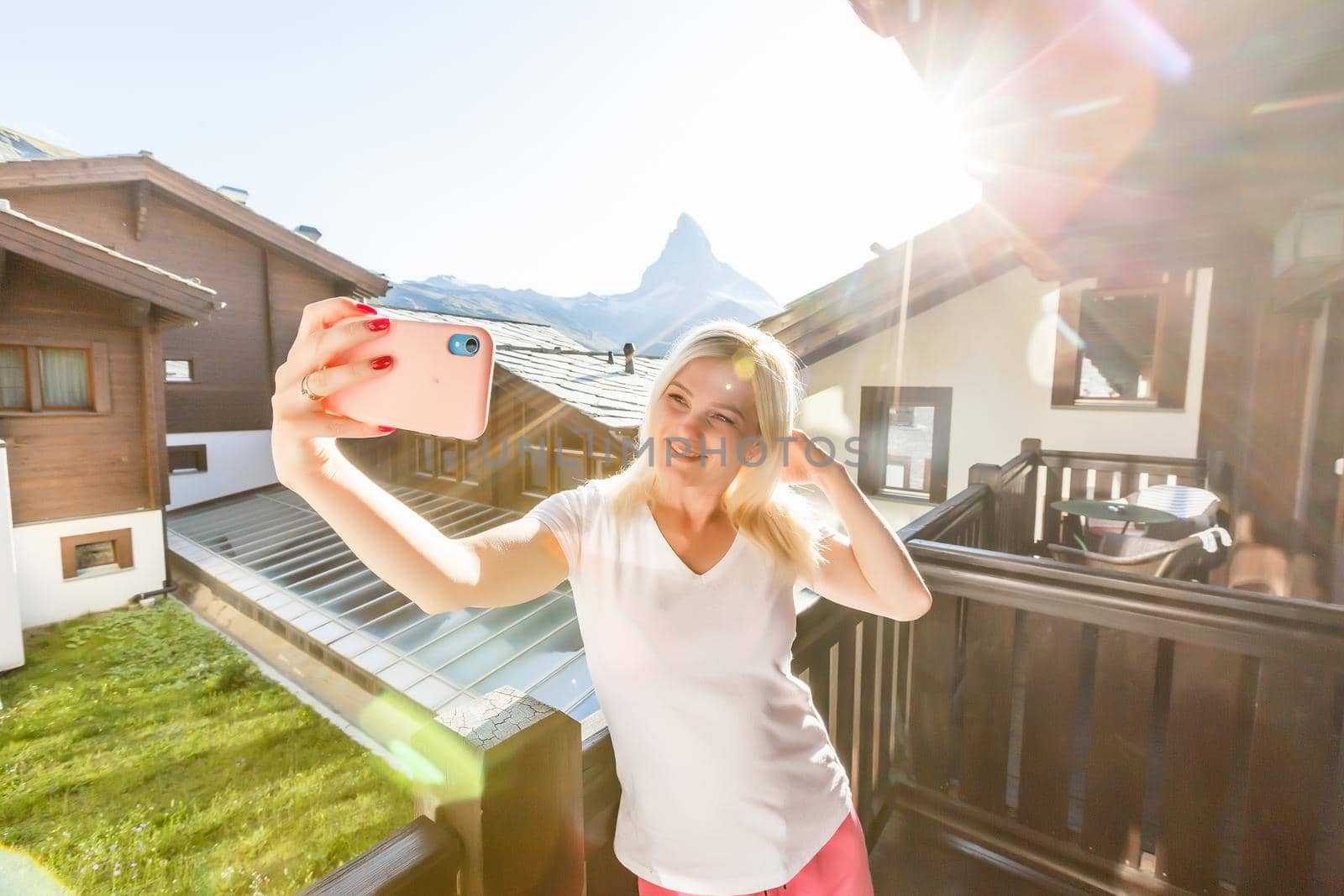 Sunny summer morning in Zermatt village with Matterhorn peak on backgroud. Beautiful outdoor scene in Swiss Alps, Switzerland, Europe.