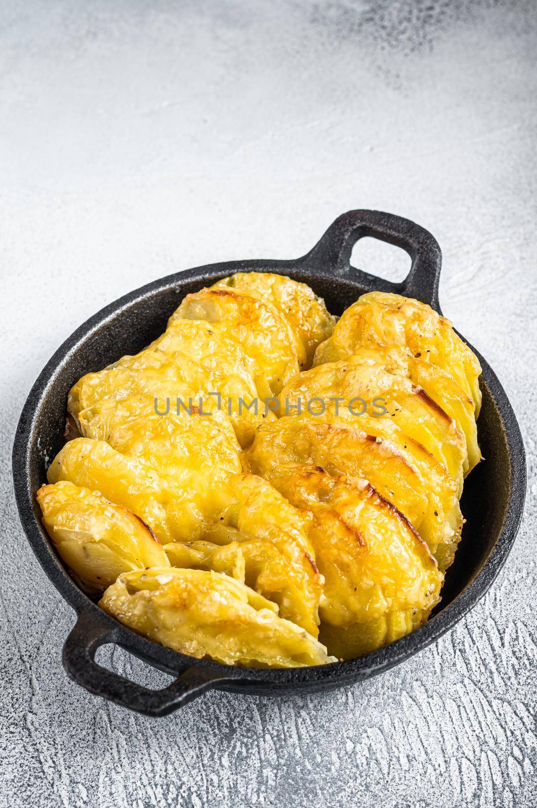 Baked Potato Gratin Dauphinois in a pan. White background. Top View by Composter