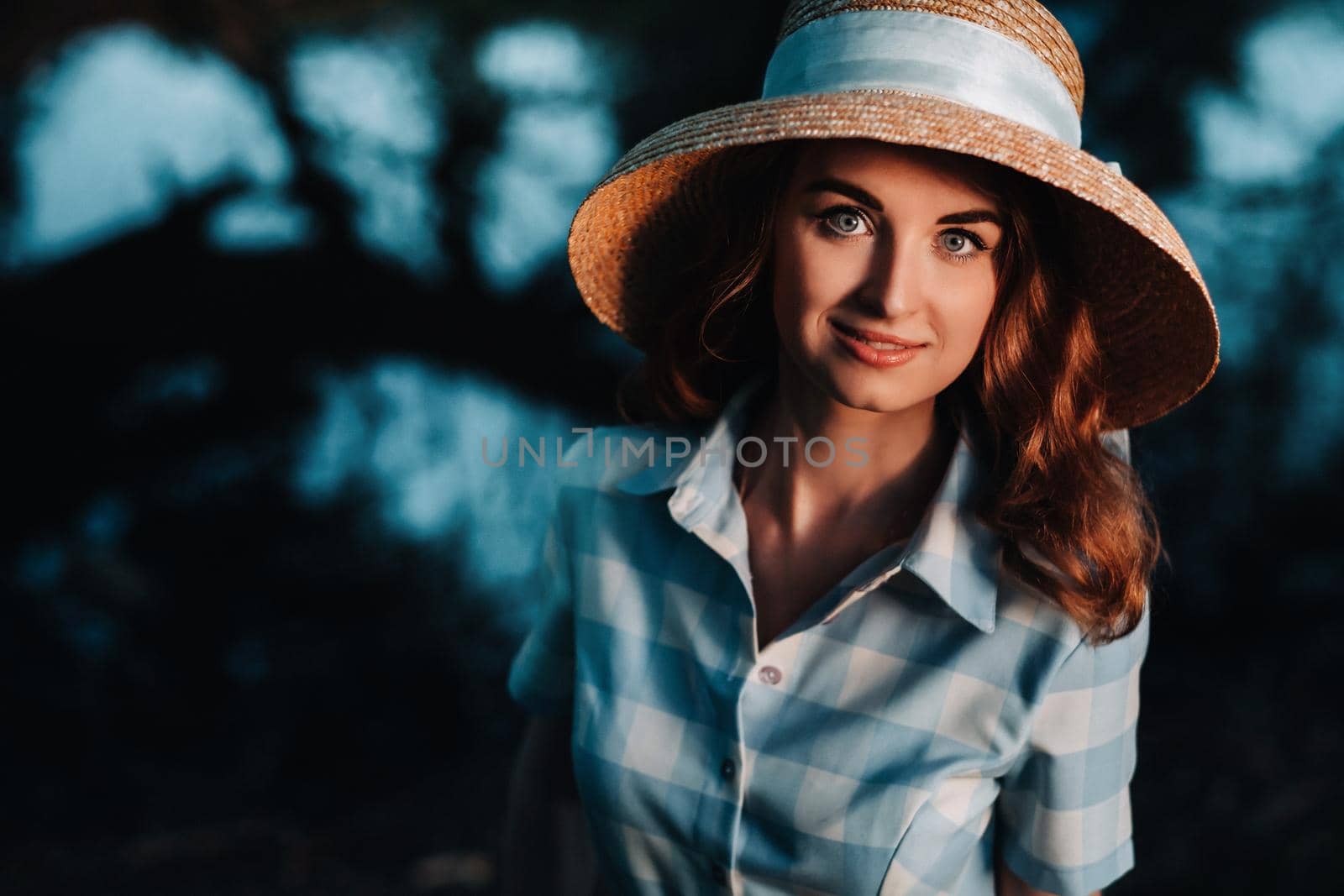 Portrait of a beautiful young lady in a straw hat.