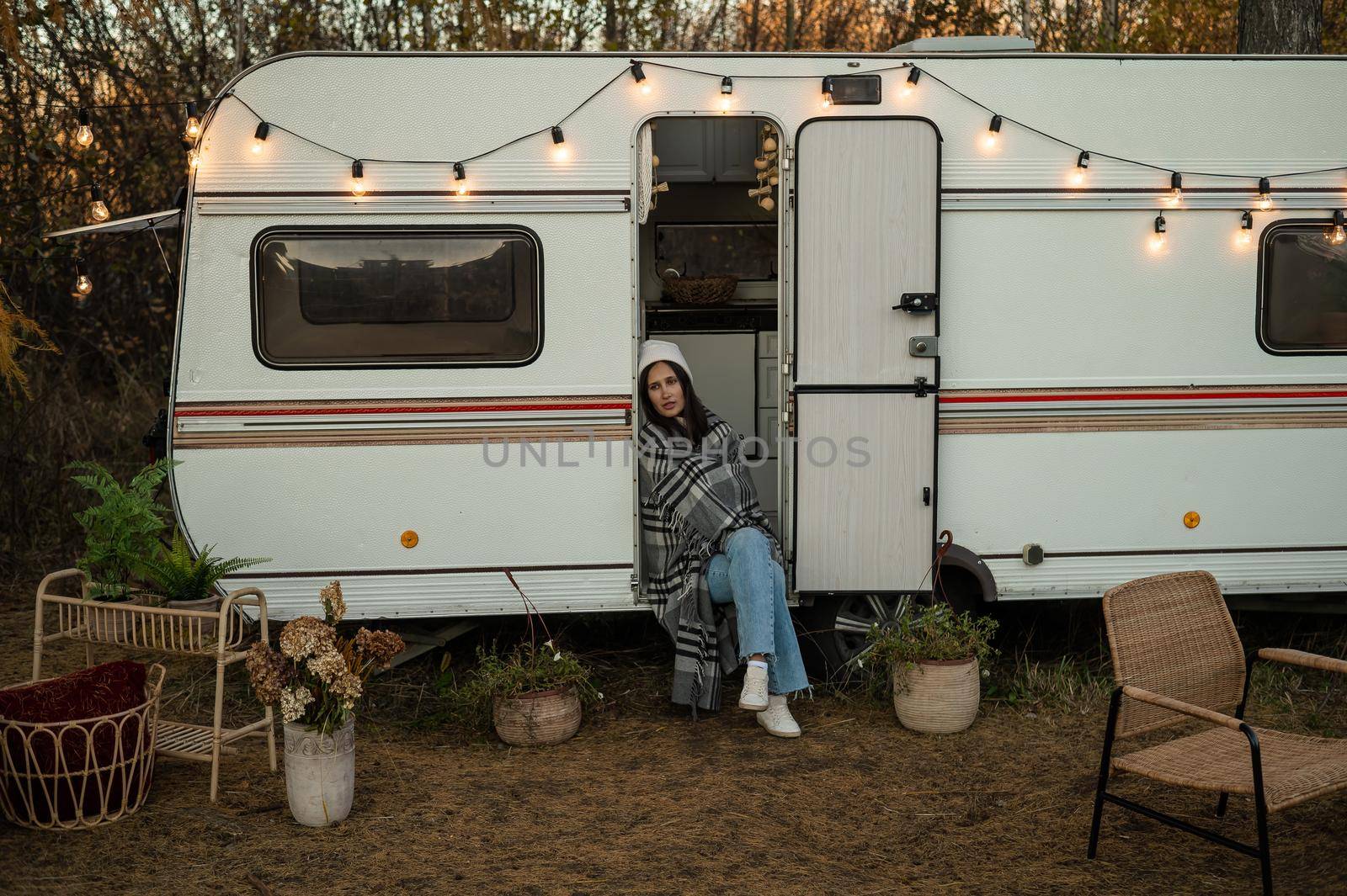 Caucasian woman sits in a van on a warm autumn day. Travel in a camper. by mrwed54