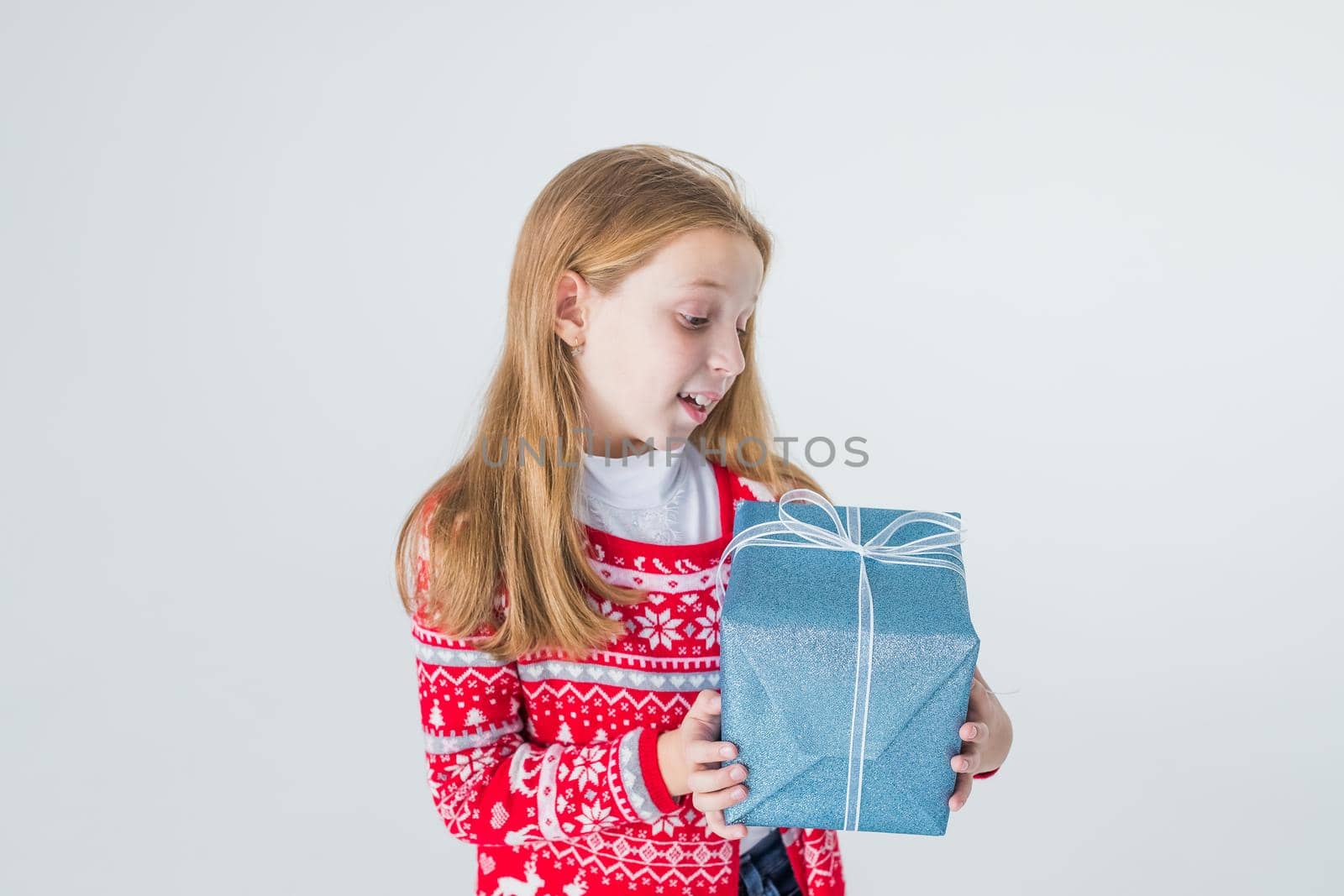 happy little girl open box with christmas present, isolated on white background