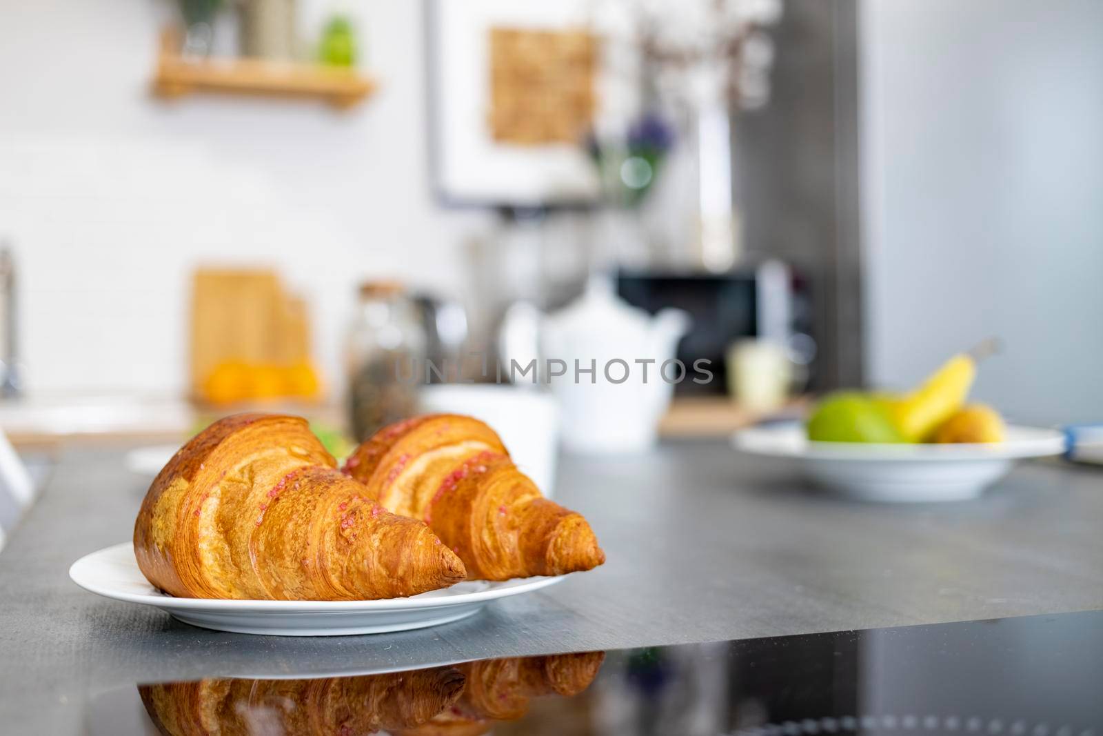 close-up of delicious croissants lie on a plate on the kitchen table. selective focus, blurred background. gluten free dietic food