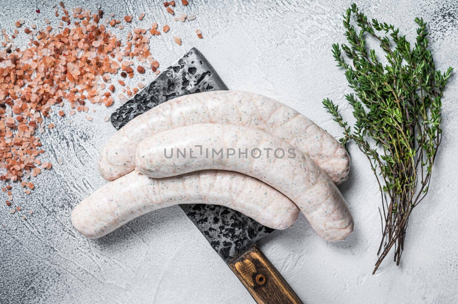 Bavarian traditional white sausages on a meat cleaver. White background. Top view by Composter