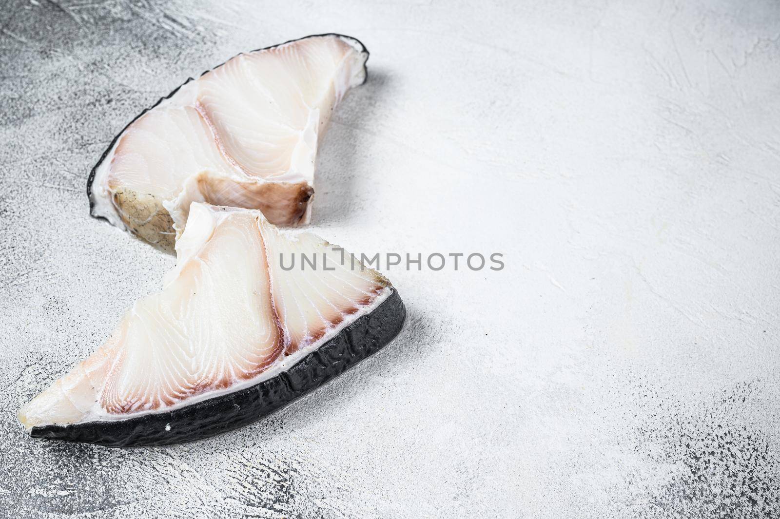 Raw Shark fish steaks on a kitchen table. White background. Top view. Copy space.