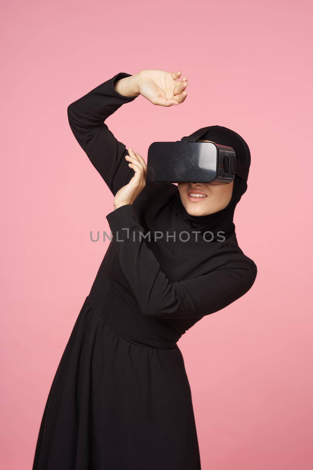 woman in black hijab glasses virtual reality technology movie watching by Vichizh