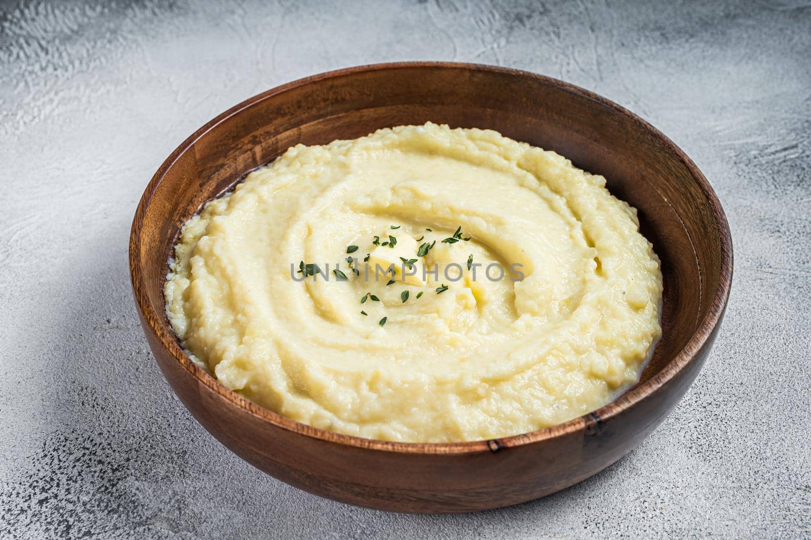 Boiled potato puree, Mashed potatoes in a wooden plate. White background. Top view by Composter