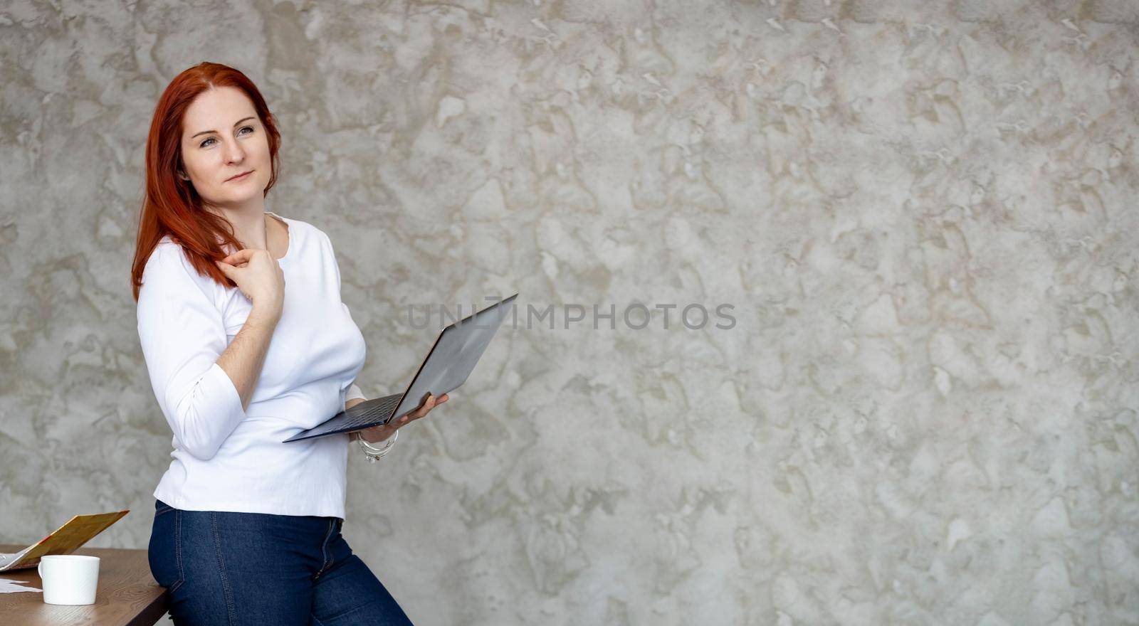 happy attractive woman with laptop. banner education, banner for remote job or computer repair service. grey background