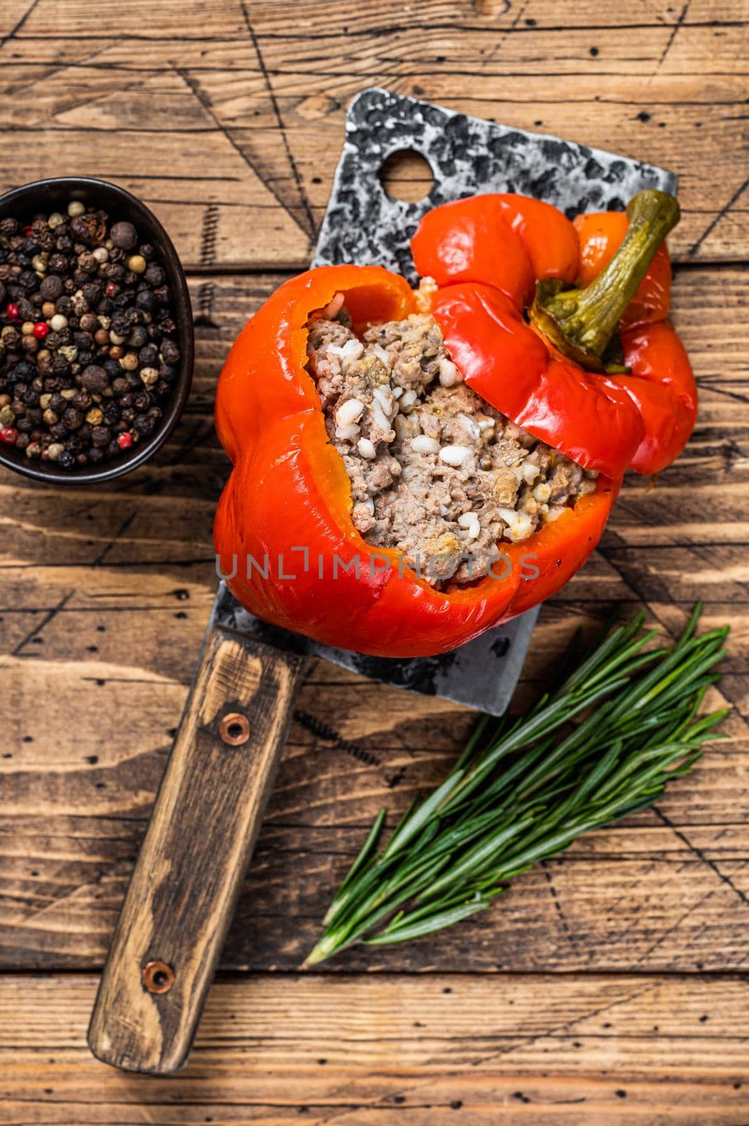 Roasted sweet bell pepper with meat, rice and vegetables. wooden background. Top view by Composter