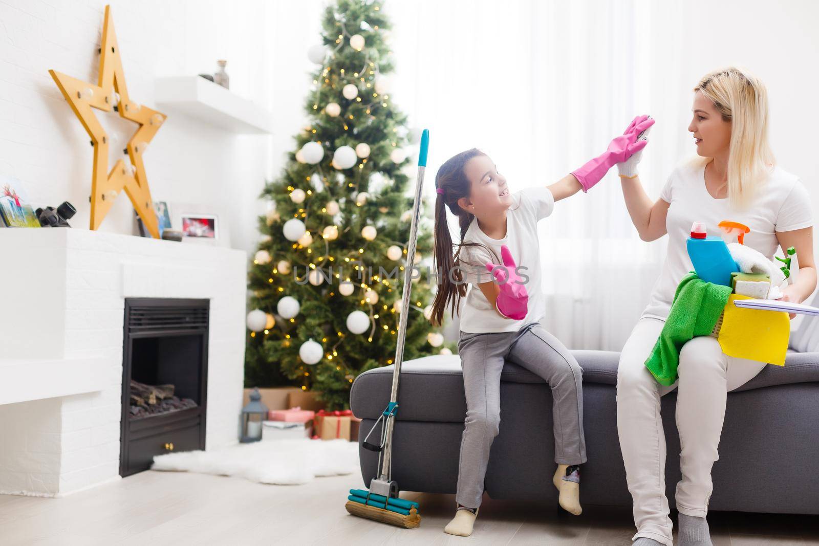 daughter and mother cleaning the apartment before christmas by Andelov13
