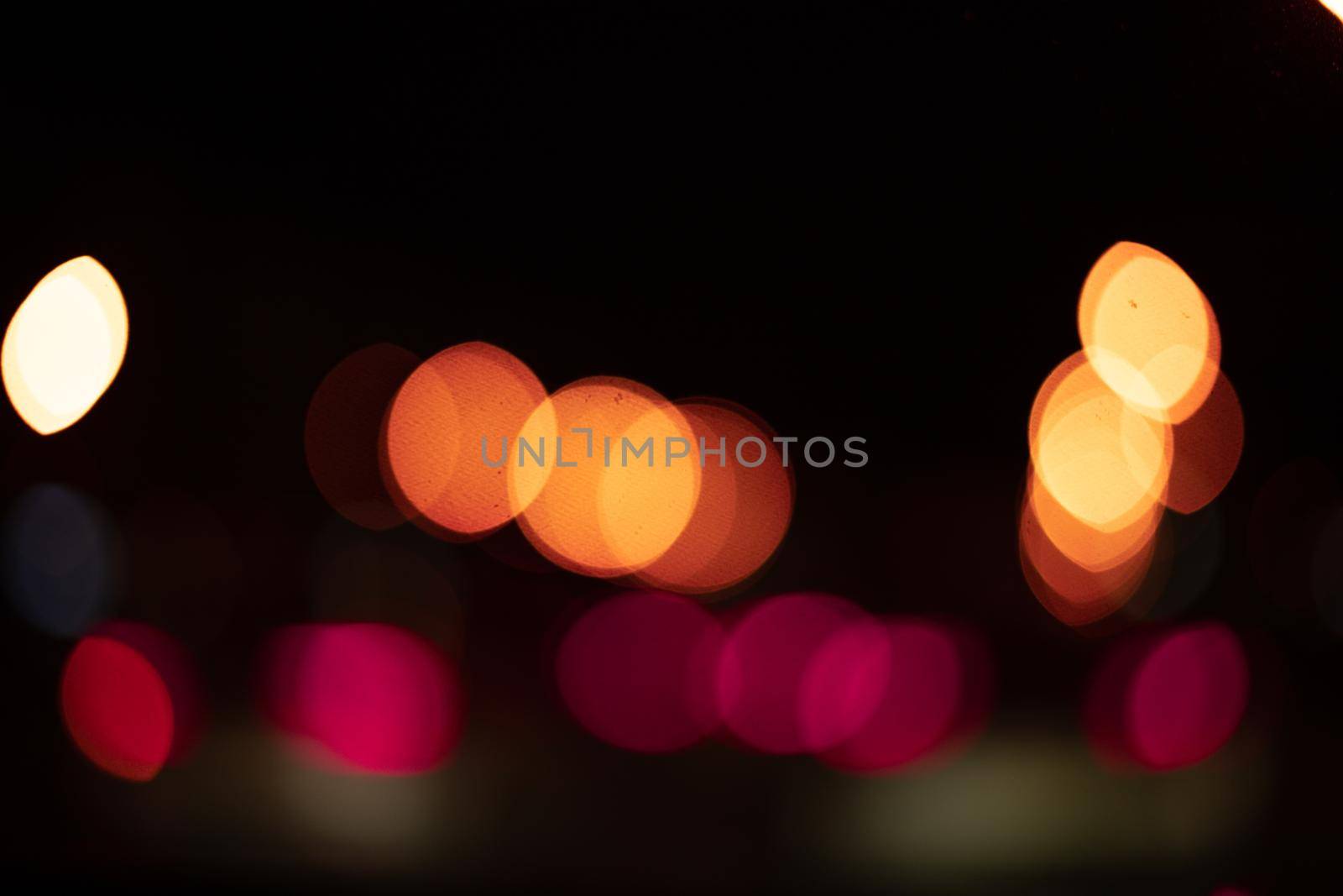 abstract glare of light with bokeh in blur on a black background. texture,night city lights and cars in blur.