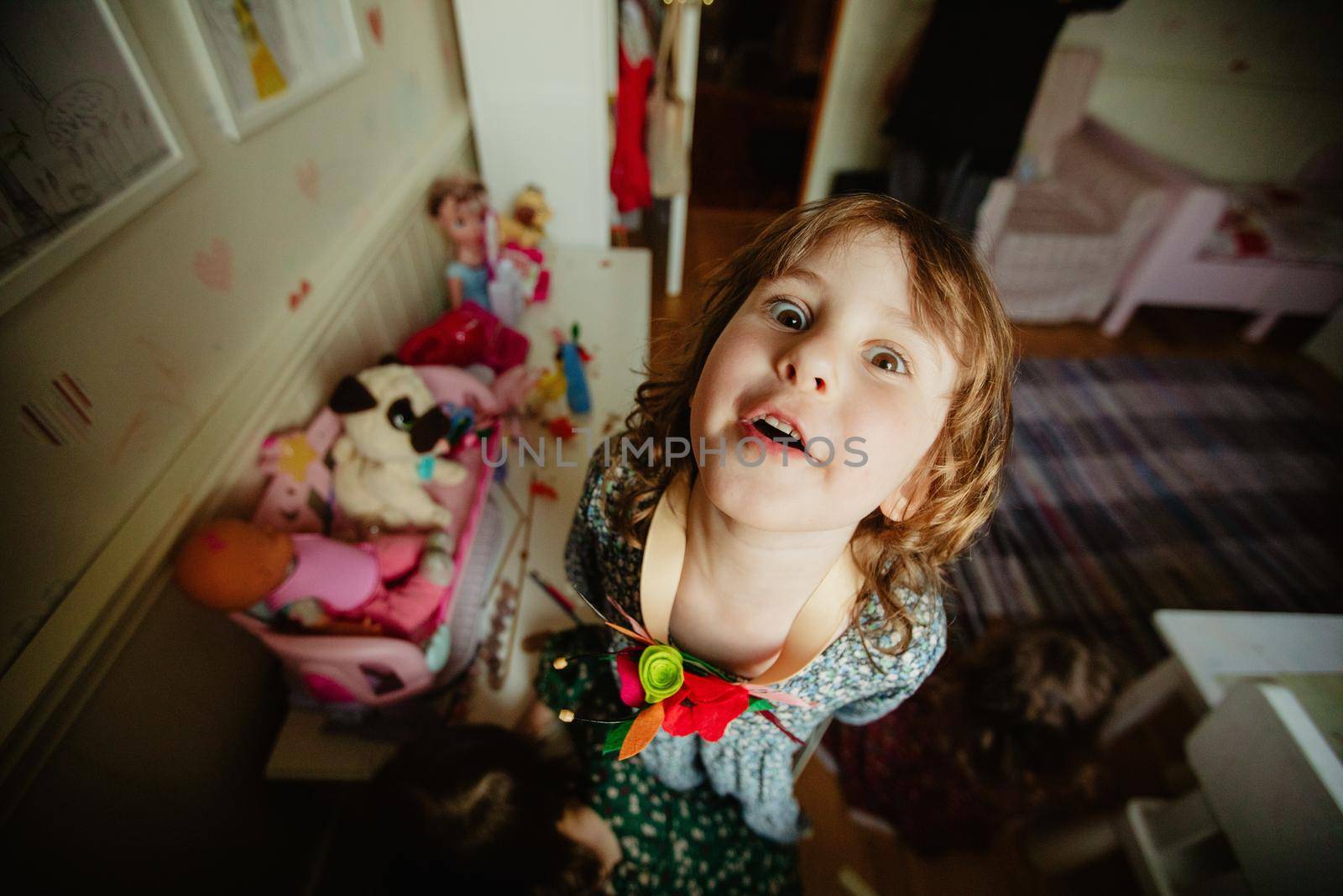 Funny child looking at camera in nursery by Demkat