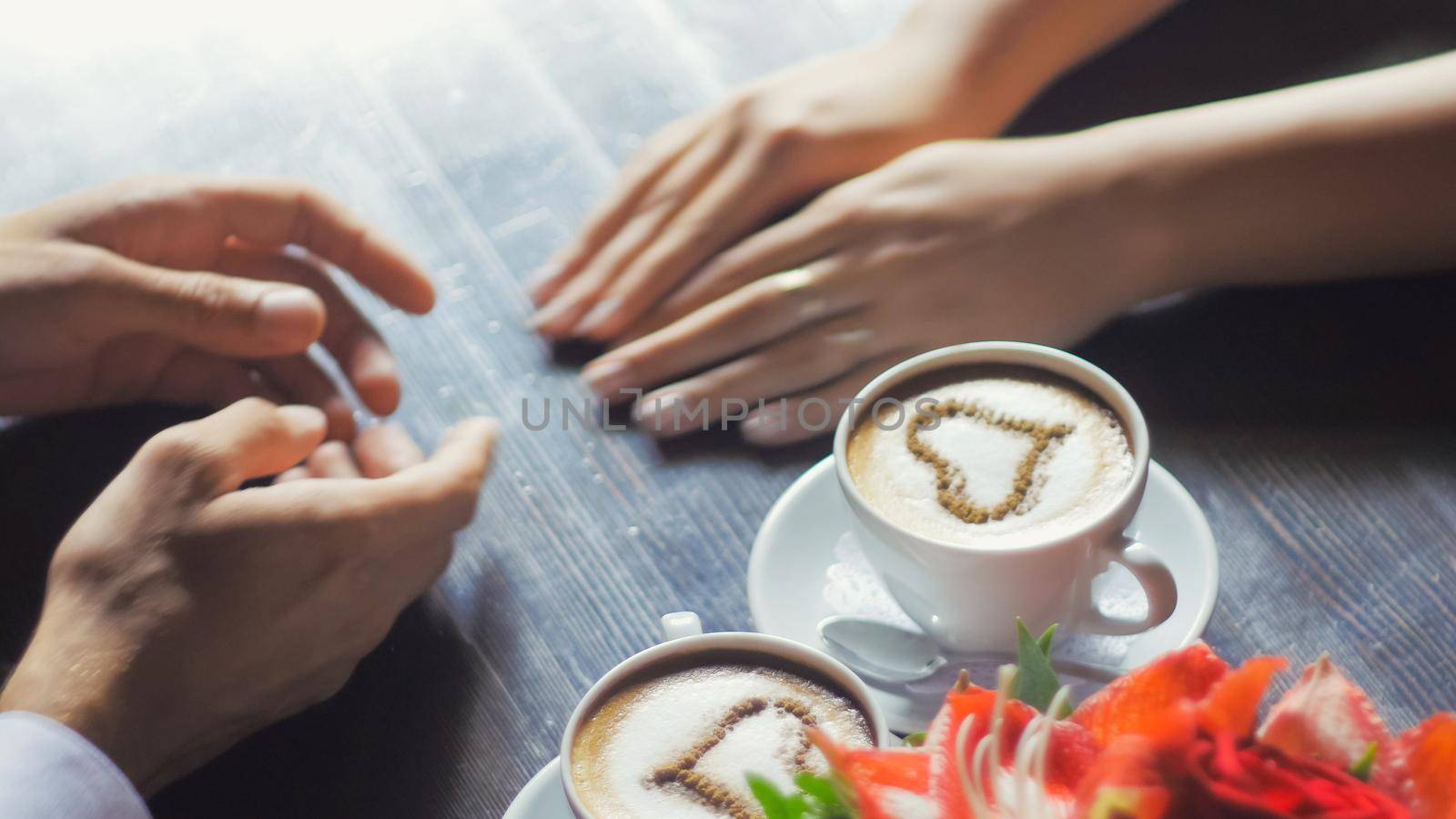 Couple holding hands coffee cappuccino, heart, view from above