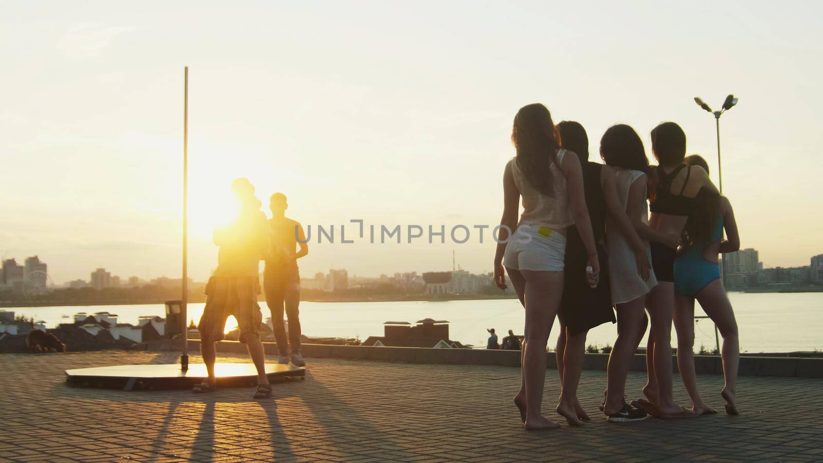 The photographer photographing group of beautiful girl at sunset by Studia72