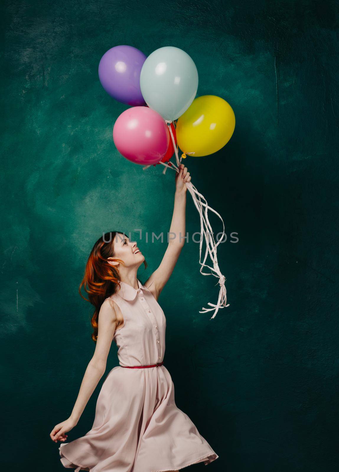 cheerful woman with colorful balloons birthday fun. High quality photo