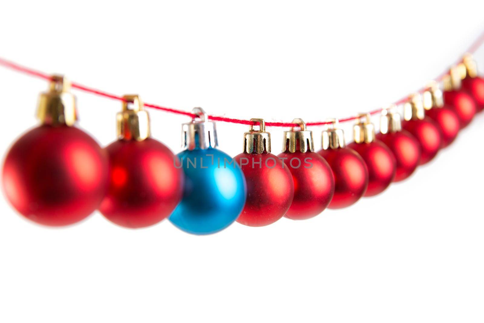 Line of red and blue christmas balls on white background. Christmas decorations. .