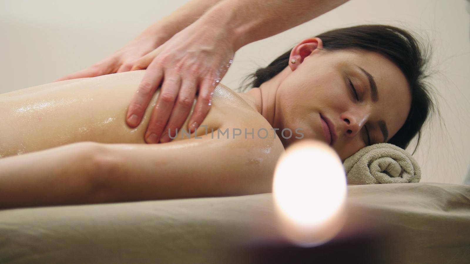 Oil massage - man's hands on the back of the black hair girl by Studia72