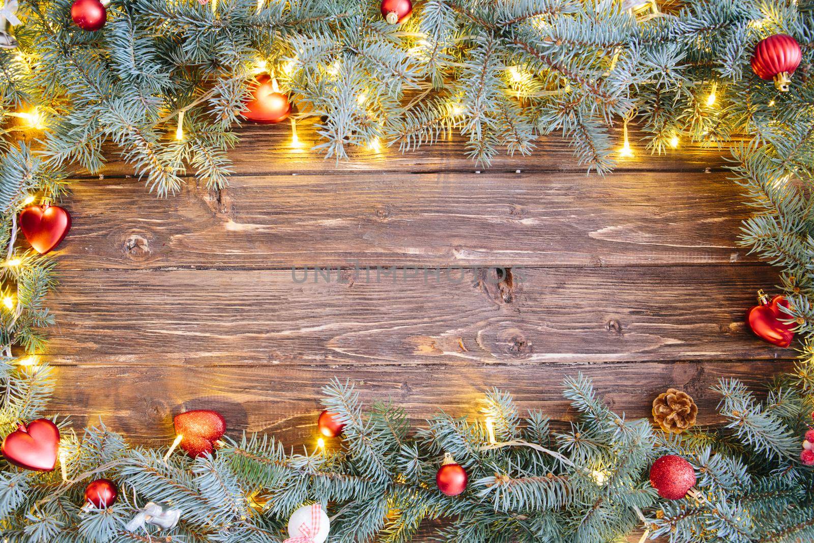 Christmas background with fir tree and decoration on dark wooden board .