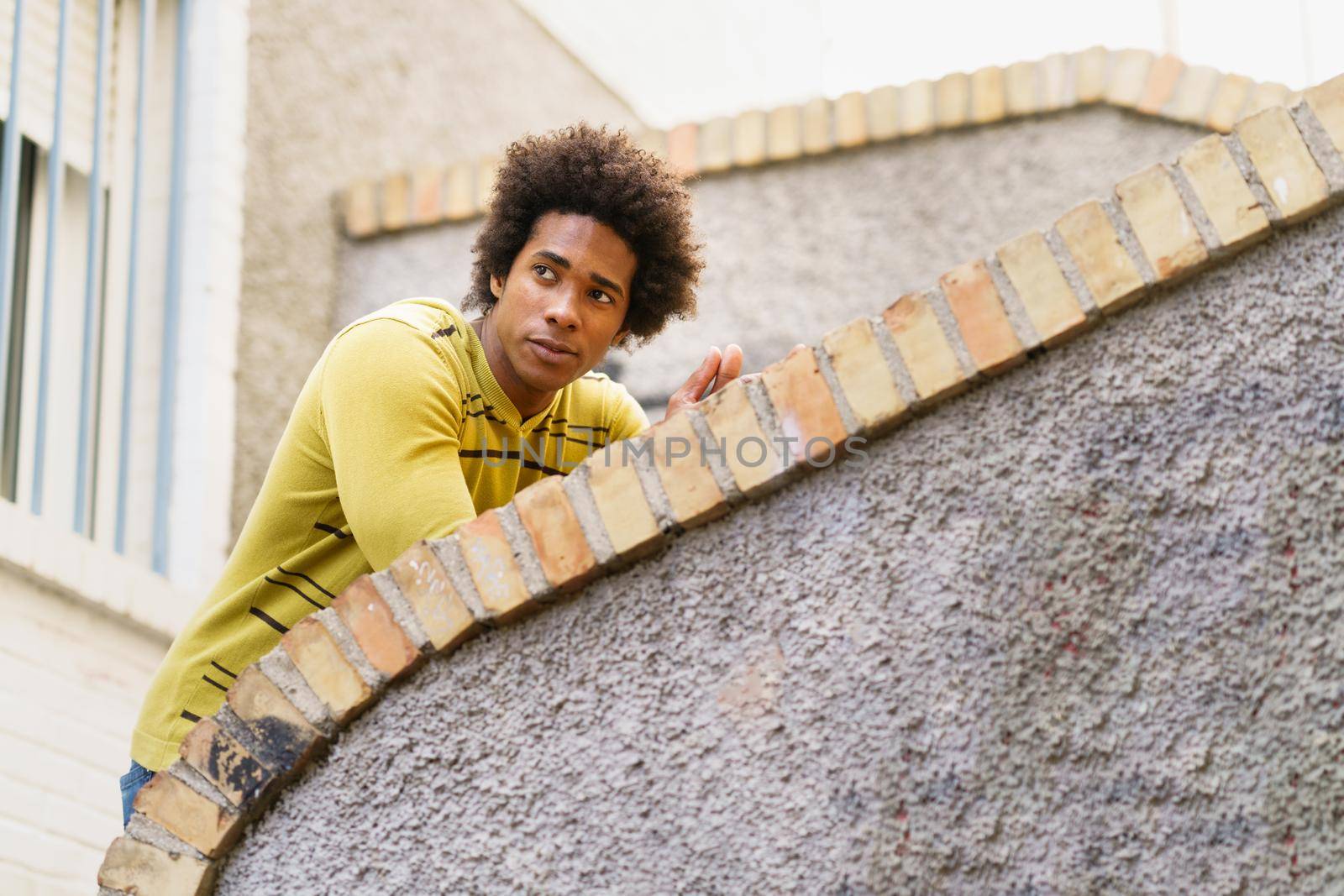 Cuban Black man with afro hair sightseeing in Granada, Andalusia, Spain.