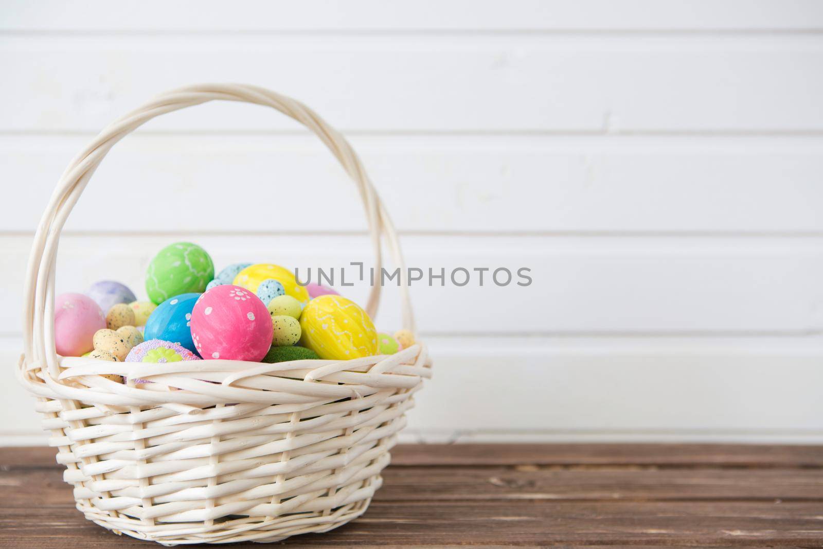 Easter eggs in nest on rustic wooden planks. .