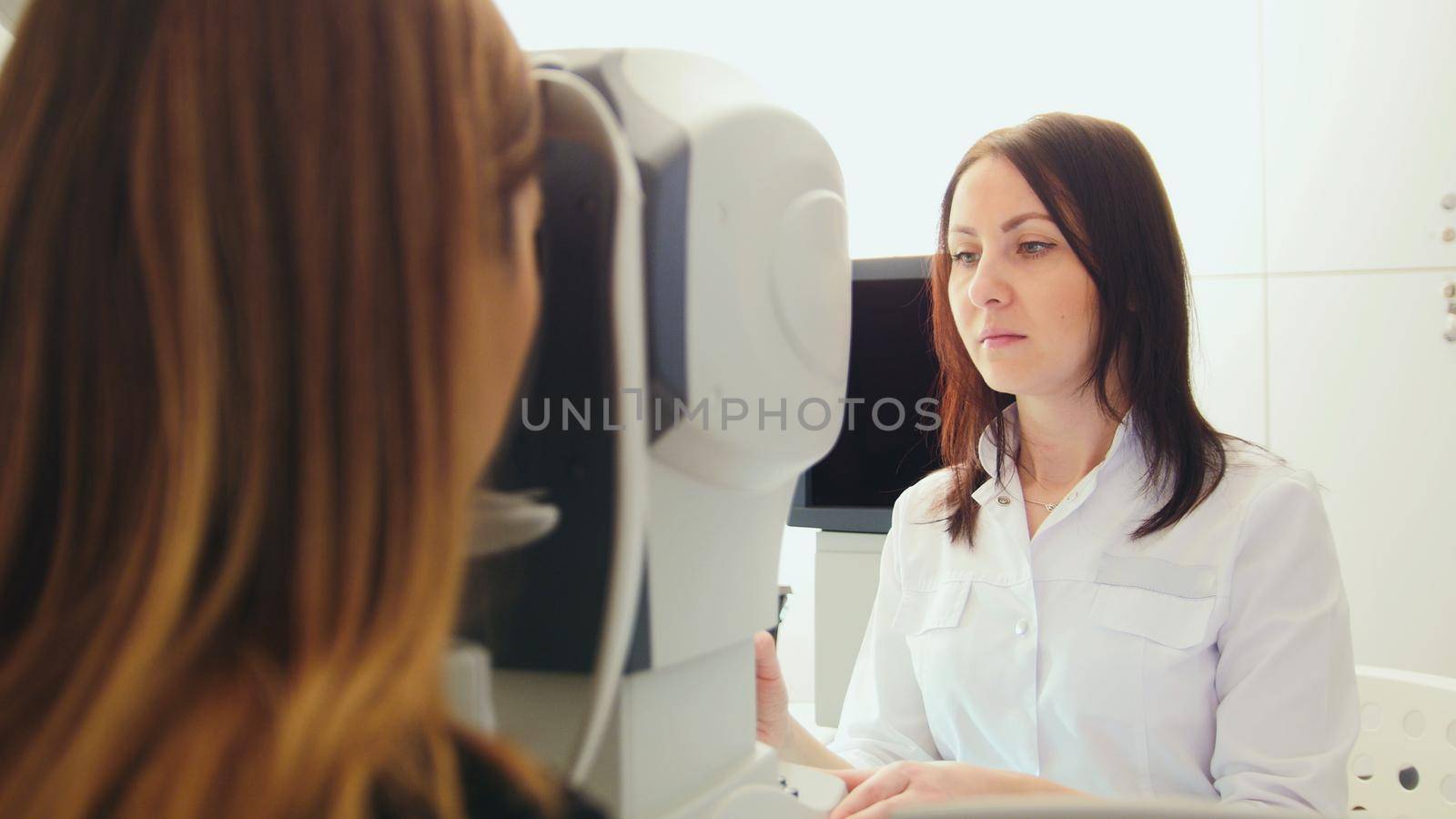 Ophthalmologist in eyes clinic doing diagnostic with vision for patient - high healthcare technology in medicine, horizontal