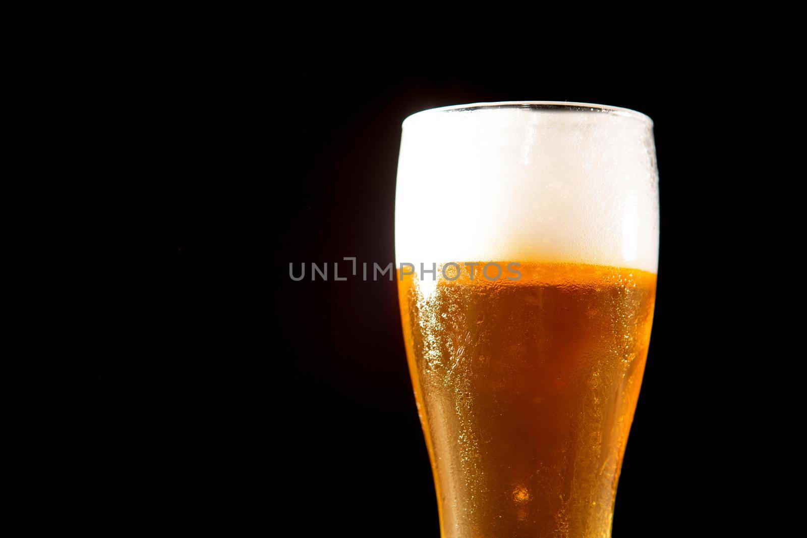 Glass beer on a black background with copyspace