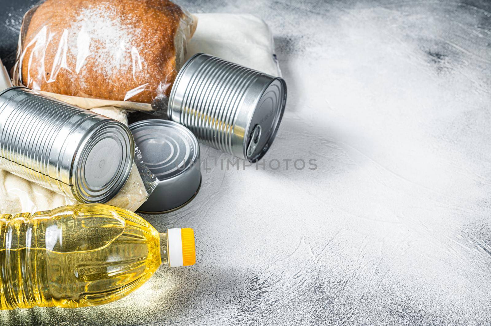Donation food goods, quarantine help concept. Oil, canned food, pasta, bread, sugar, egg. White background. Top view. Copy space.