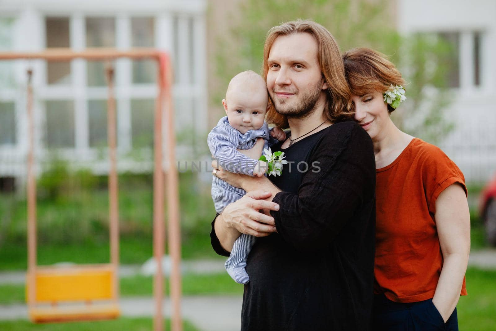 Happy family with baby on playground outdoors by Demkat