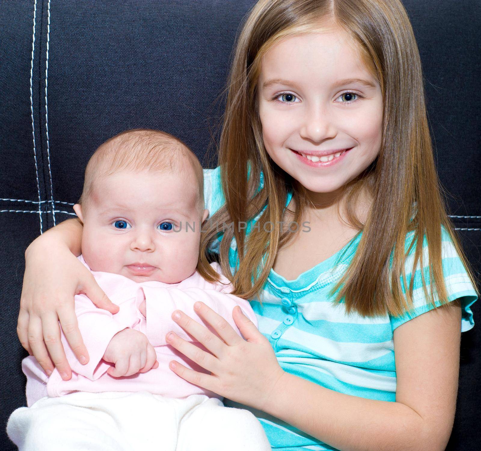 Adorable little girl and her newborn sister