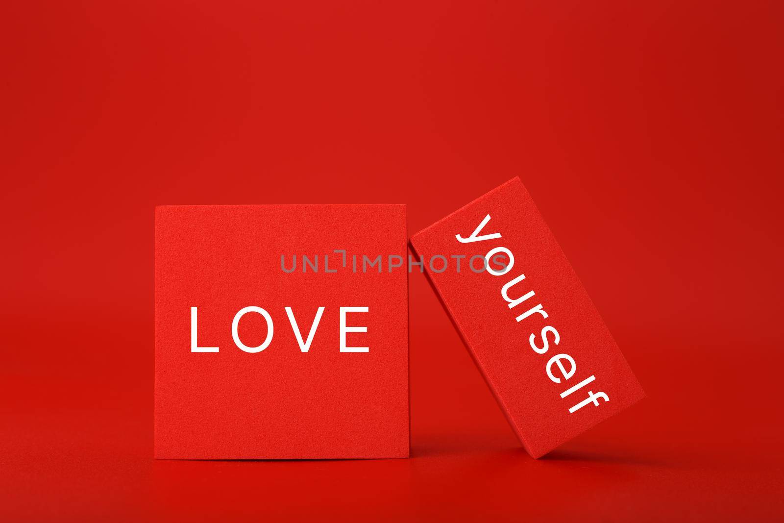 Trendy minimal self love creative concept in monochromatic red colors. Mental health, self acceptance, self care and respect or being single concept.