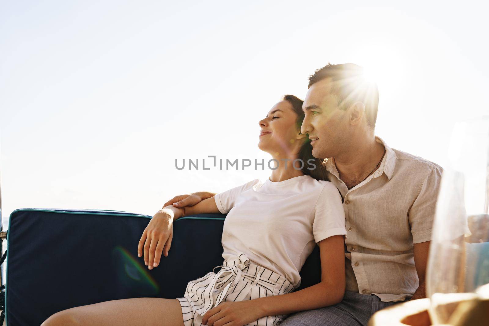 Happy couple on a yacht in summer on romantic vacation by Fabrikasimf