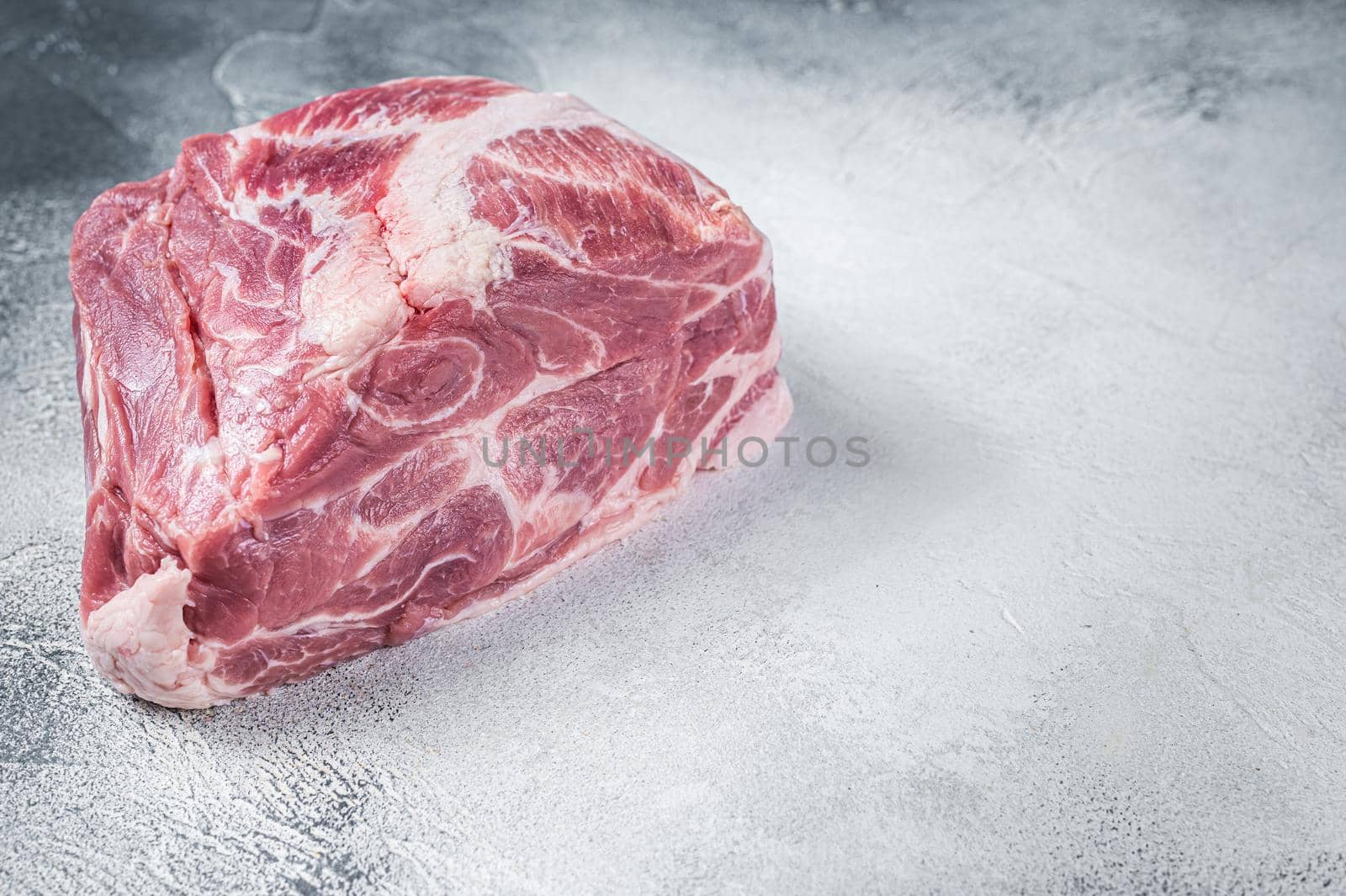 Raw pork neck meat for Chop steak on kichen table. White background. Top view. Copy space by Composter